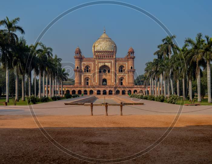 A Mesmerizing,Isometric View With Palm Trees And Blue Sky Of Safdarjung Tomb Memorial From The Main Gate,Entrance At Winter Morning.