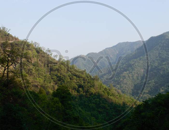 The View Of Mountain, Blue Sky, Greenery, The Beauty Of Nature Of The Famous Neer Waterfall, Rishikesh, Uttarakhand, India.