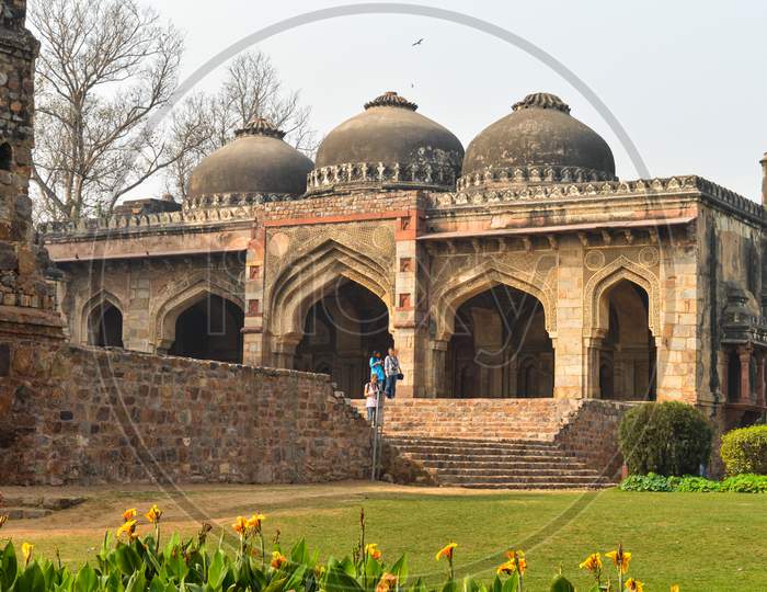 A Bada Gumbad Monument At Lodi Garden Or Lodhi Gardens In A City Park From The Side Of The Lawn At Winter Foggy Morning.