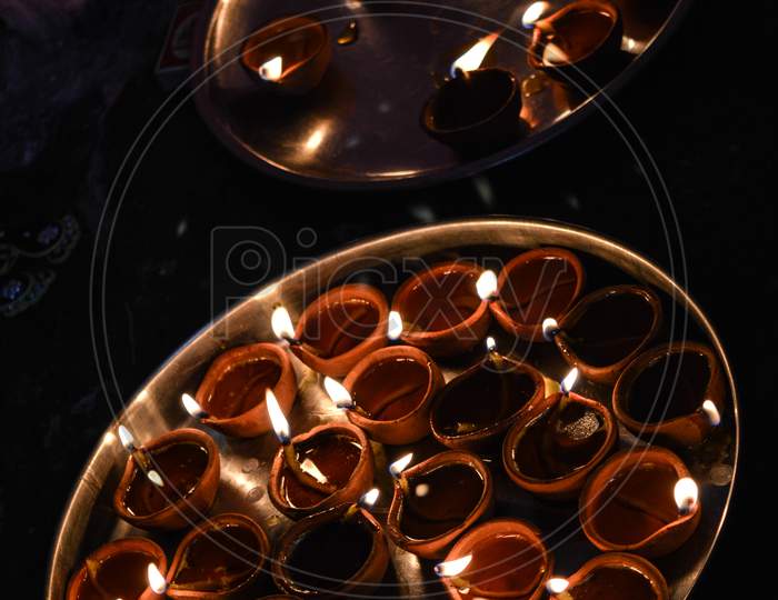 A Plate Is Which Is Loaded With Rose And Candle On Indian Festival Diwali Deepawali With Fire Isolated On Table