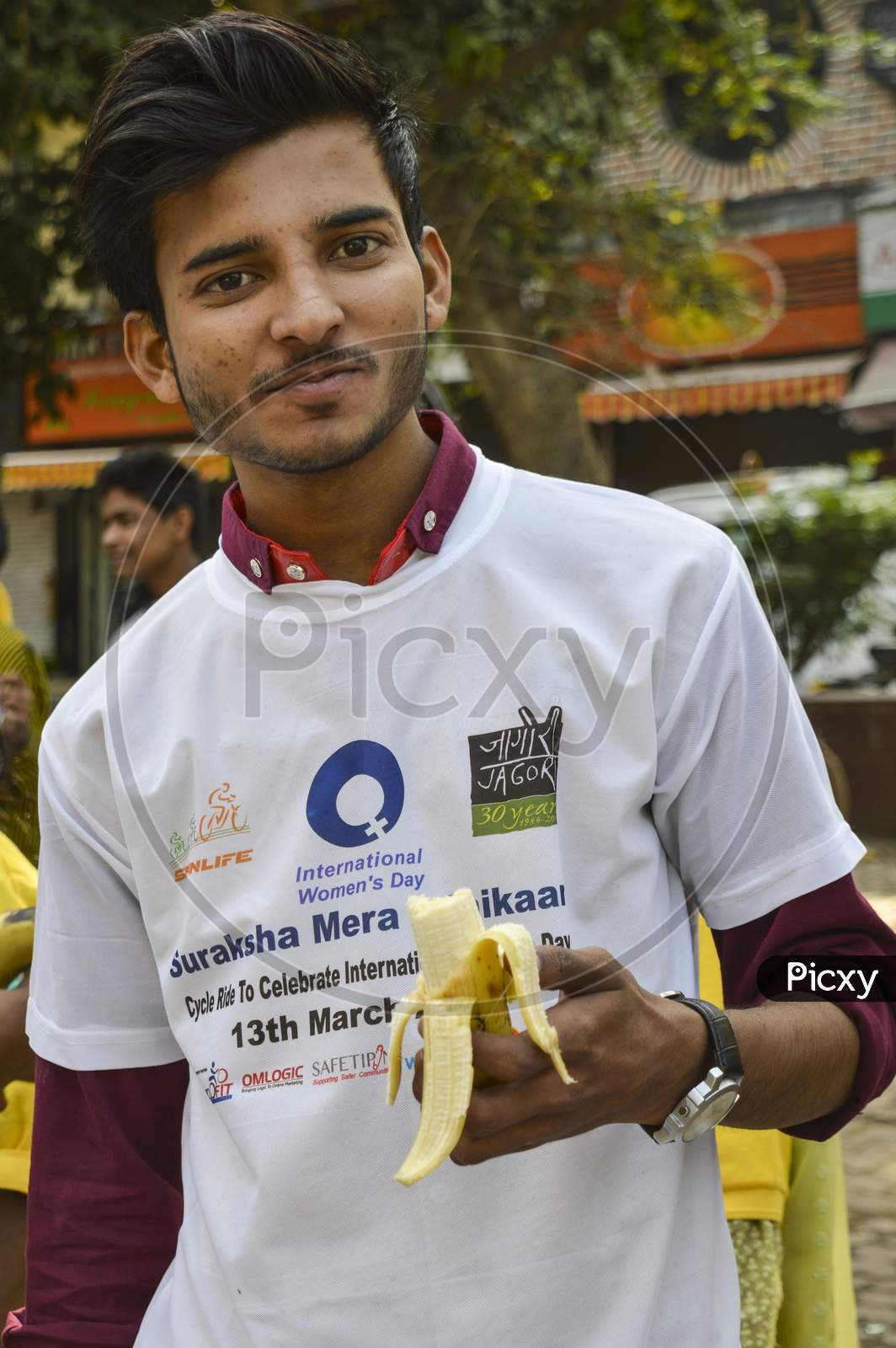 A Indian Boy Having The Food At Event For Support The Cycle Ride To Celebrate International Women'S Day.