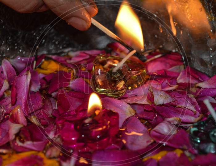 A Indian Lady Lit Up Jar Is Which Is Loaded With Rose And Candle On Indian Festival Diwali Deepawali With Fire Isolated On Table