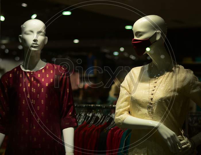 Salwar And Mask Are Displayed On Two Mannequin In A Garment Store