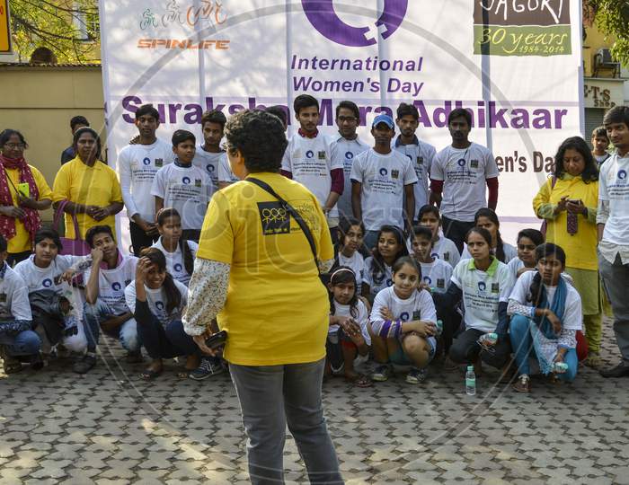 A Group Of Indian People Poses For Support The Cycle Ride To Celebrate International Women'S Day.