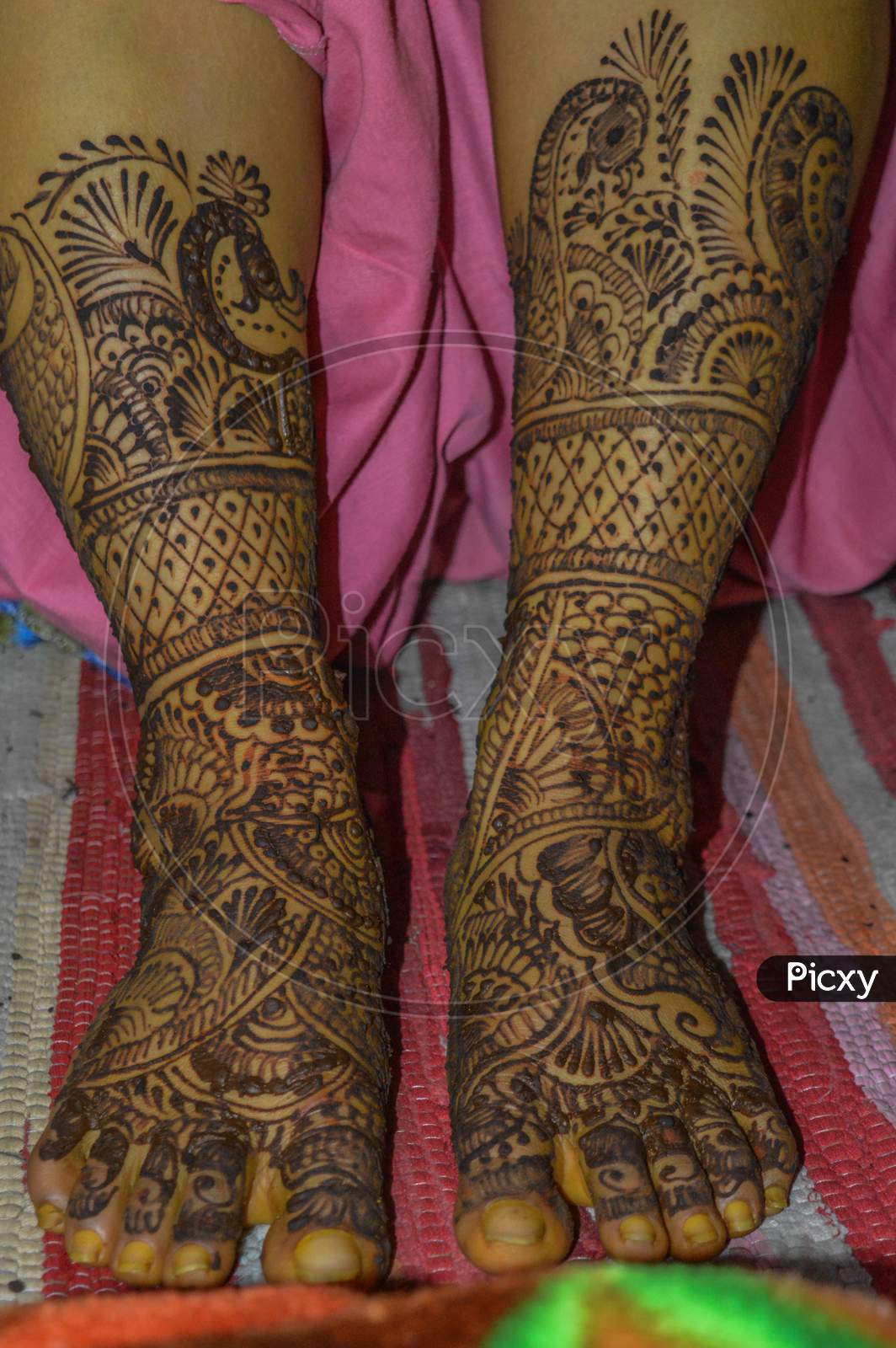 A Lady Feet With Indian Heena Mehandi In Indian Weddings.