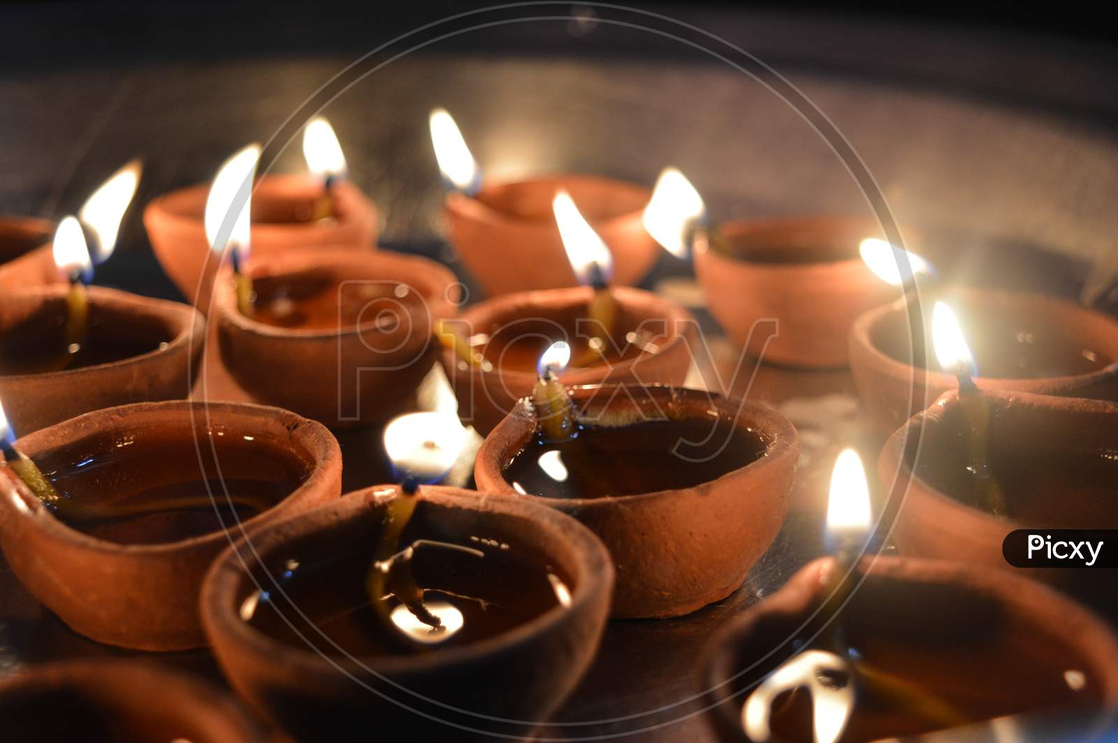 A Plate Is Which Is Loaded With Rose And Candle On Indian Festival Diwali Deepawali With Fire Isolated On Table