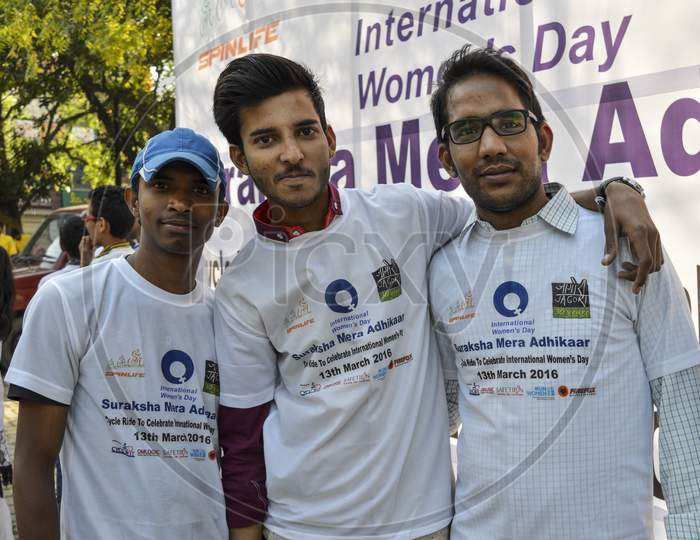 A Group Of Indian People Poses For Support The Cycle Ride To Celebrate International Women'S Day.