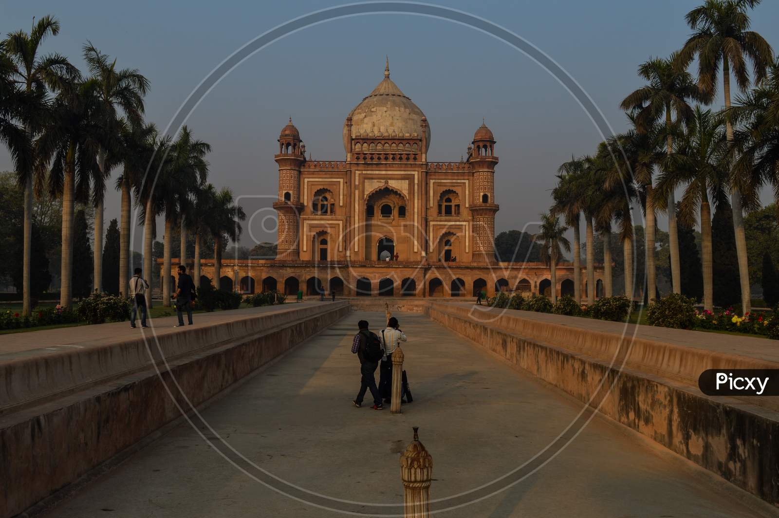 A Bunch Of Photography Students Standing And Taking Picture In-Front Of Safdarjung Tomb Memorial At Winter Morning.