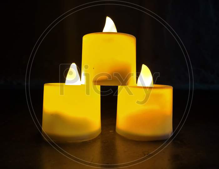 Yellow led filament candlelight lamp with black background ,Traditional festival lamp (diya) during a festival celebration on Gujarat, India.