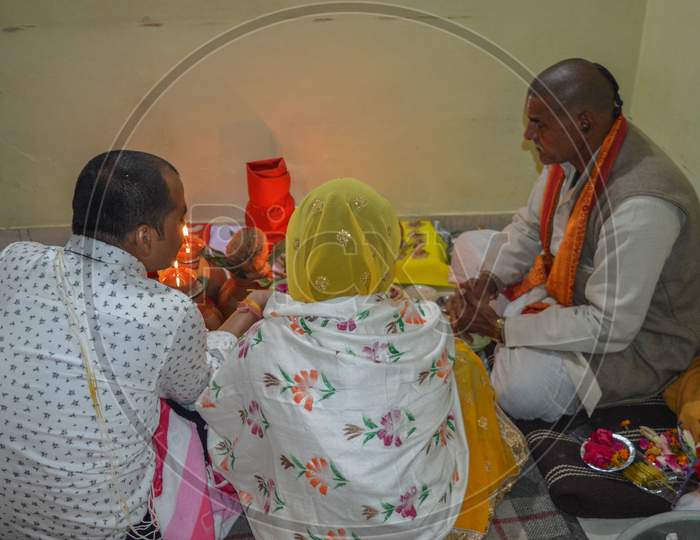 A Indian Couple And Pujari Doing Worship Of Indian God.