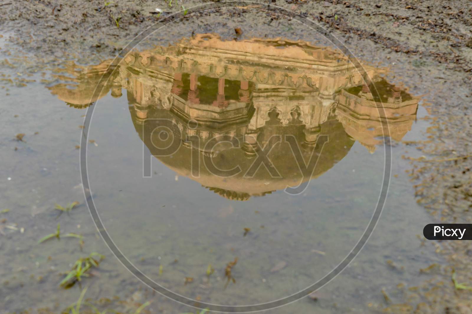 A Reflection In Water Of Tomb Of Sikandar Lodhi Monument At Lodi Garden Or Lodhi Gardens In A City Park From The Side Of The Lawn At Winter Foggy Morning.