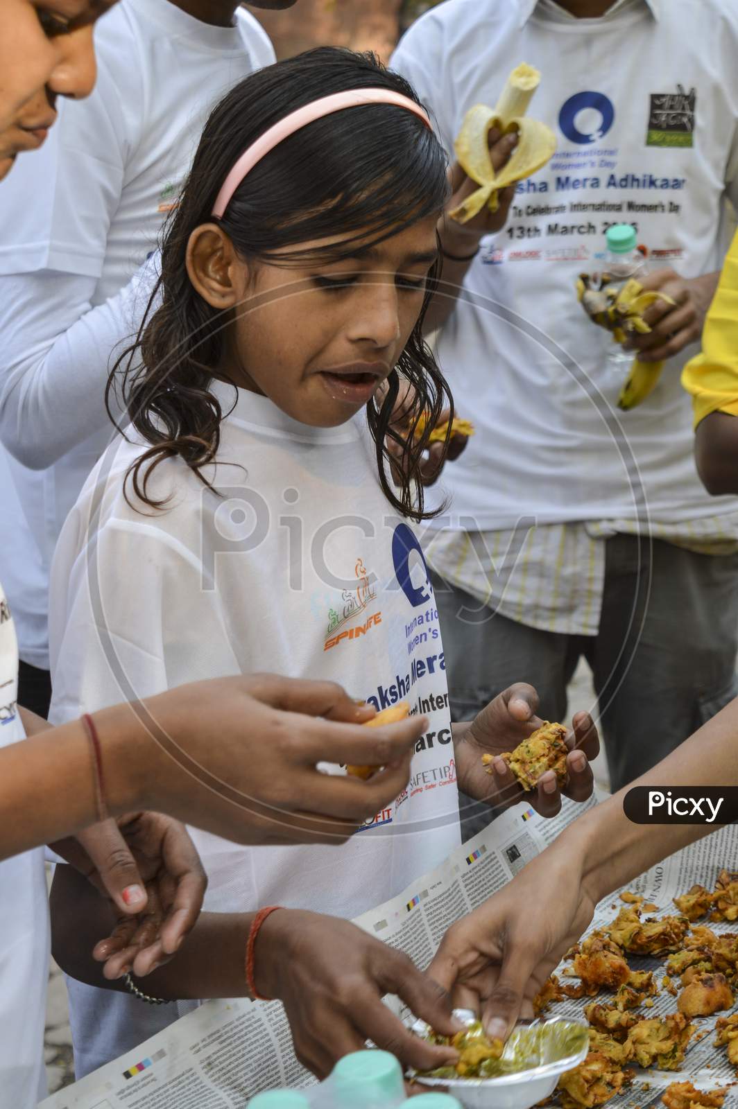 A Indian Girl Having The Food At Event For Support The Cycle Ride To Celebrate International Women'S Day.
