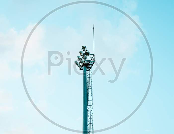 Minimalistic Close Up Of The Post Of Lights Of A Stadium With A Bright Blue Sky As The Background