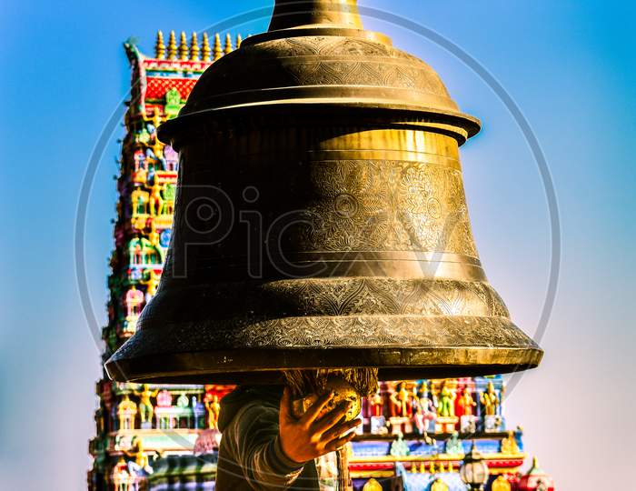A Giant Bell  with temple in background namchi sikkim