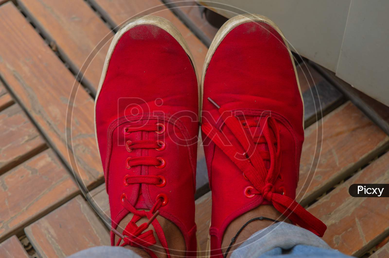 A Pair Of Dirty Red Shoes.