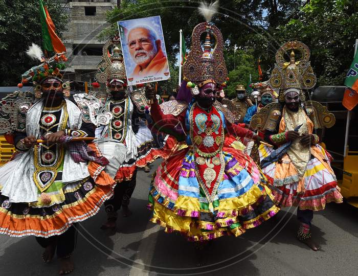 A 'Therukoothu' folk artist holds a placard with the image of Indian Prime Minister Narendra Modi during Bharatiya Janata Party (BJP) celebrations for Modi's 70th birthday, in Chennai on September 17, 2020.