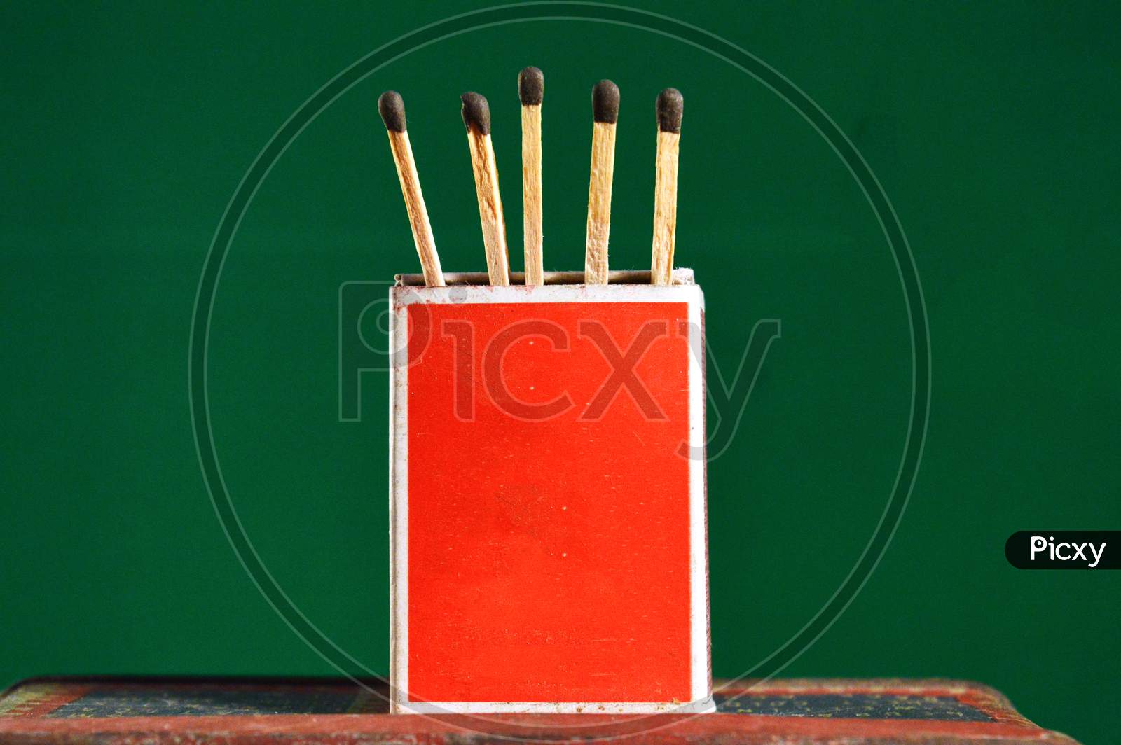 Wooden Matchsticks With Box Stand With Green Background