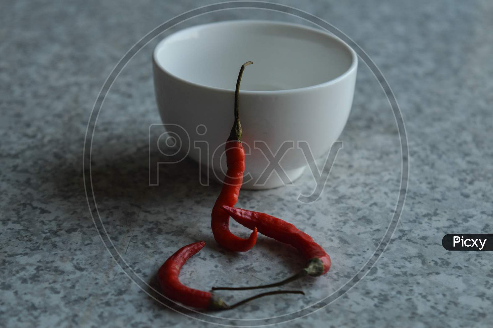 Red Chillies With White Bowl Isolated On White Texture Mable Table