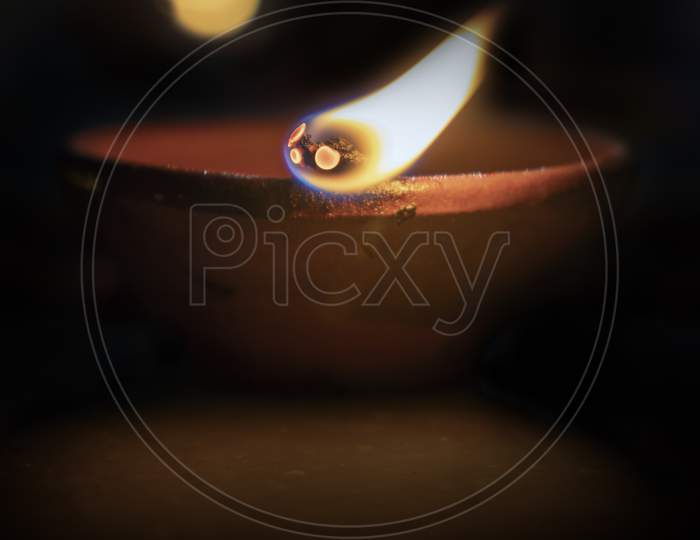 Close Up Of Lit Clay Diya(Lamp) On Diwali.