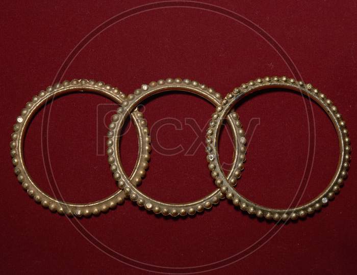 A Antique Handmade Indian Bangles Isolated On Red Background For Beautiful Hands
