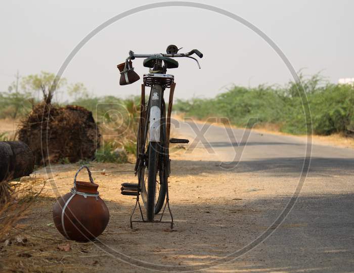A toddy pot and bicycle
