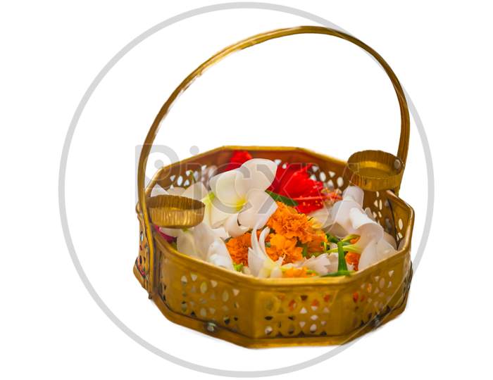 Gold brass baskets filled with flowers on a white background