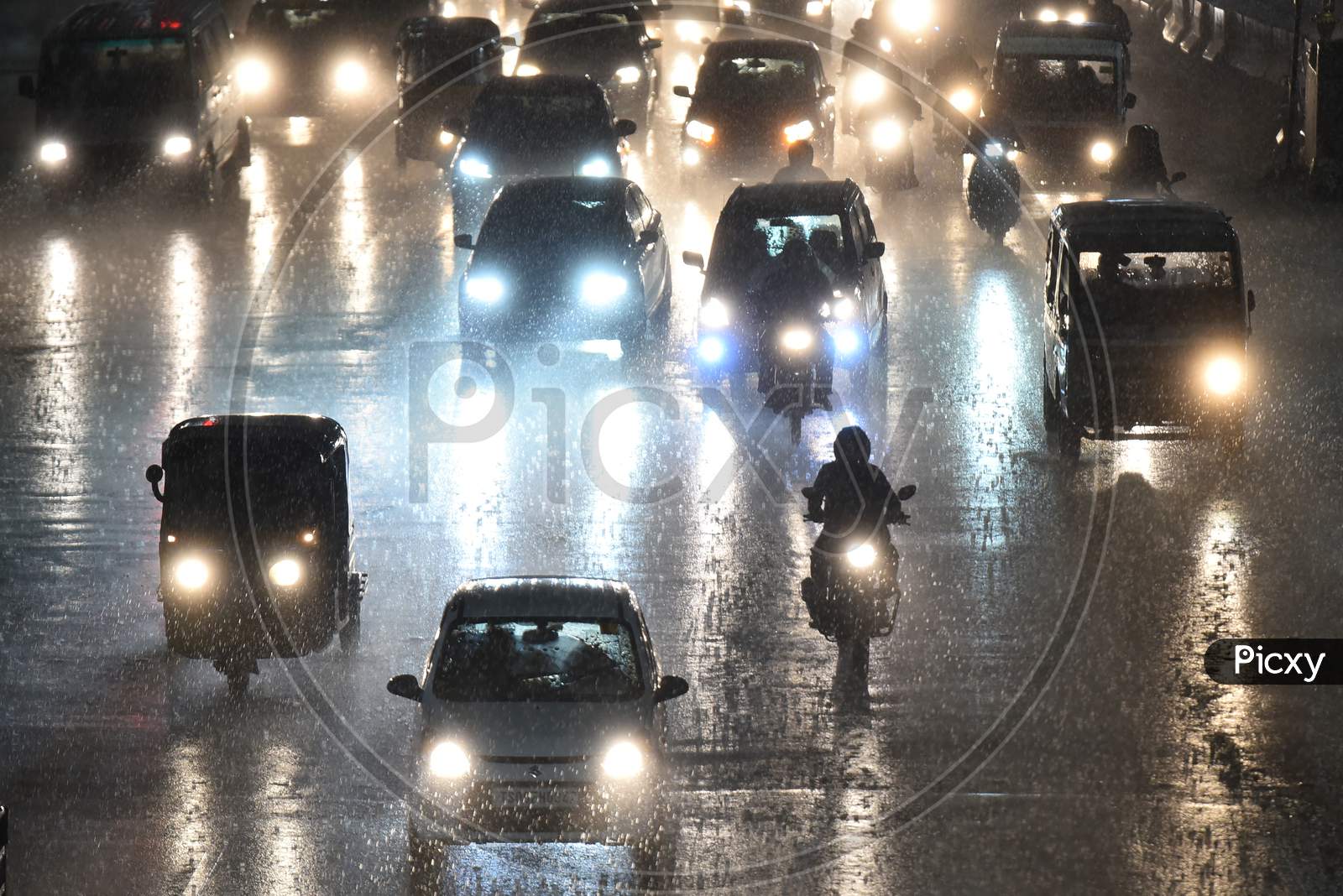 motorists drive on road as it rains heavily in Hyderabad on september 16,2020.