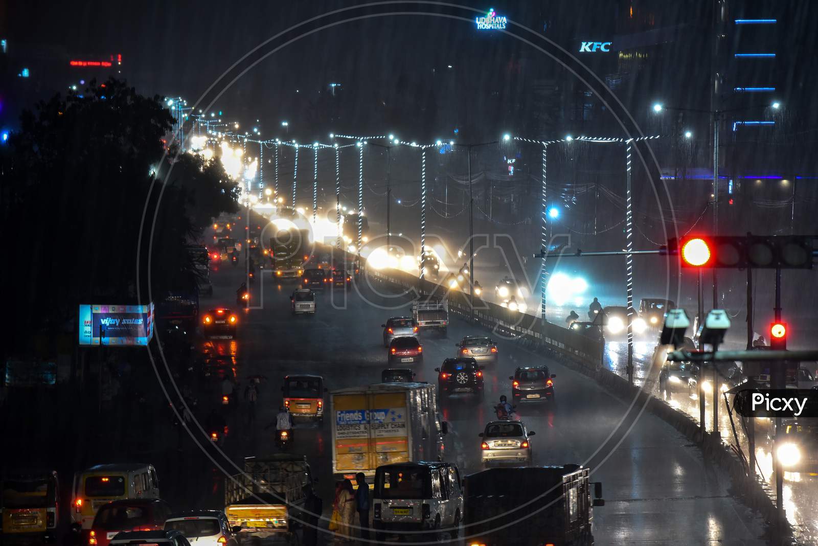 vehicles ply on road as it rains heavily in Hyderabad, September 16, 2020.