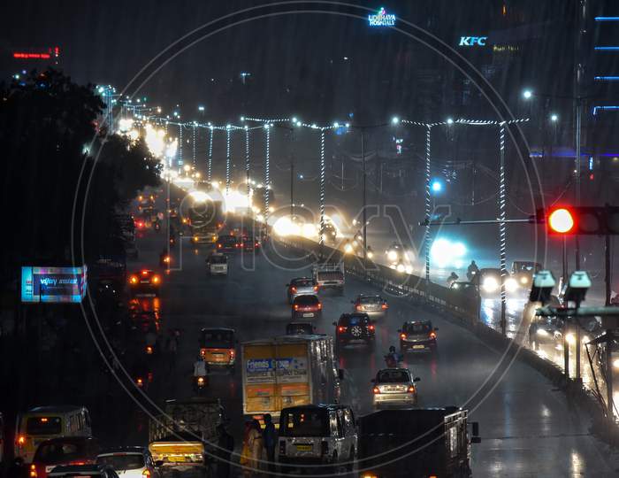 vehicles ply on road as it rains heavily in Hyderabad, September 16, 2020.