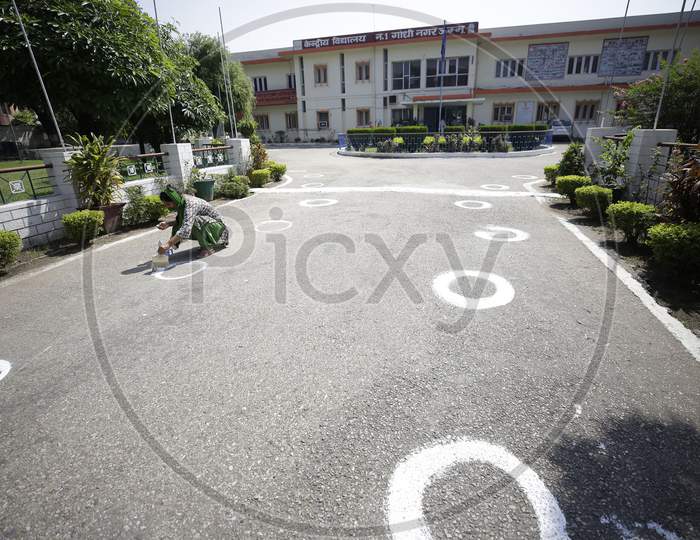 A worker drawing circles in a compound of a school in Jammu on Friday as preparations are underway to open the educational institutions for select classes after nearly six months closure next week on September 18,2020.