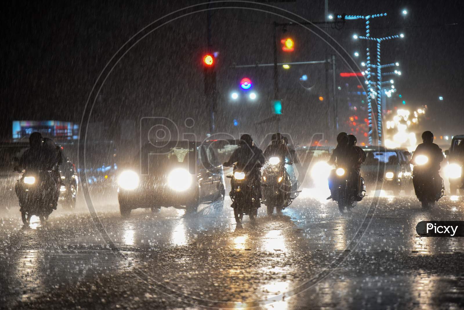 Vehicles move on road as it rains heavily in Hyderabad on September 16,2020