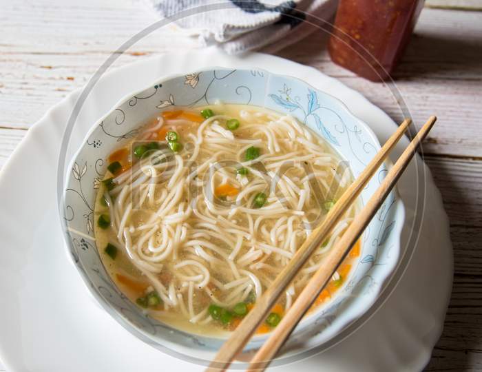 Vertical top view of Thai noodle soup with shrimp