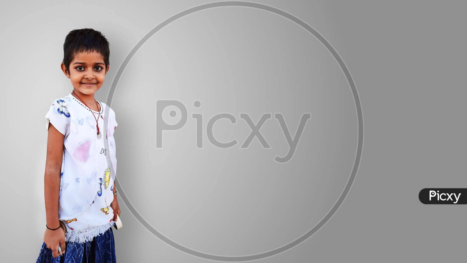 Pretty Indian Little Girl Standing And Smiling Isolated In White