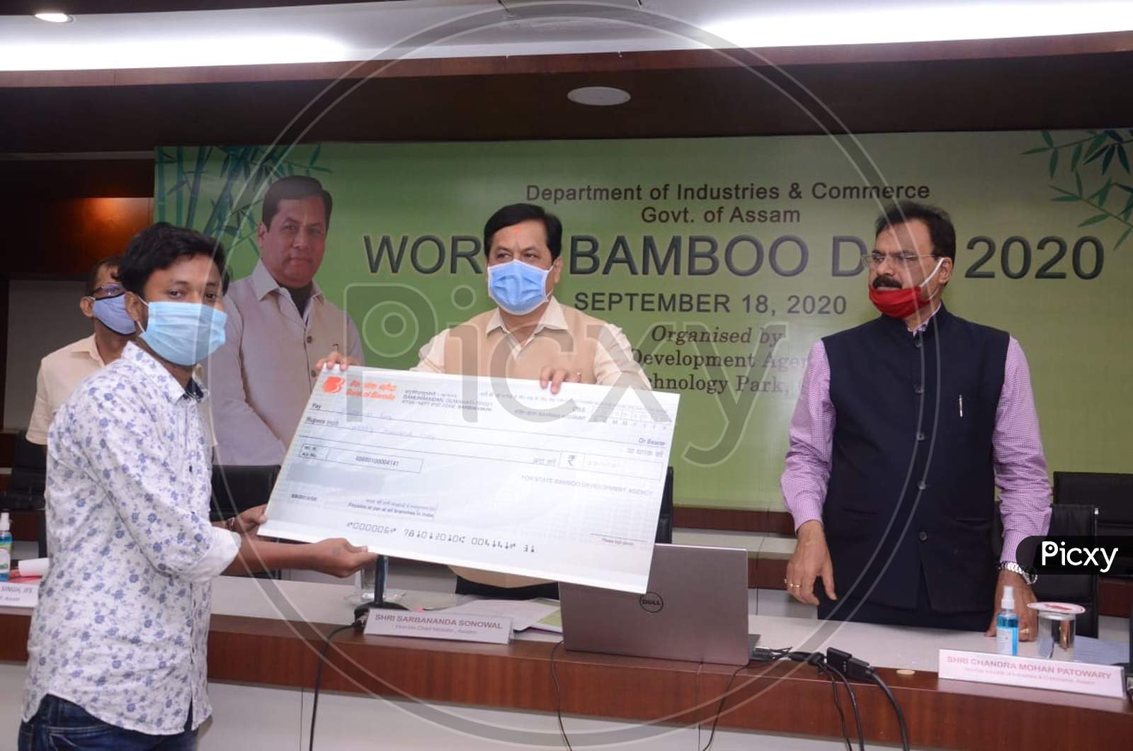 Assam Chief Minister Sarbananda Sonowal presenting a cash reward to Archana Bodo Rongpi, winner of a competition held to mark the World Bamboo Day celebration at Assam Administrative Staff College in Guwahati on September 18, 2020.