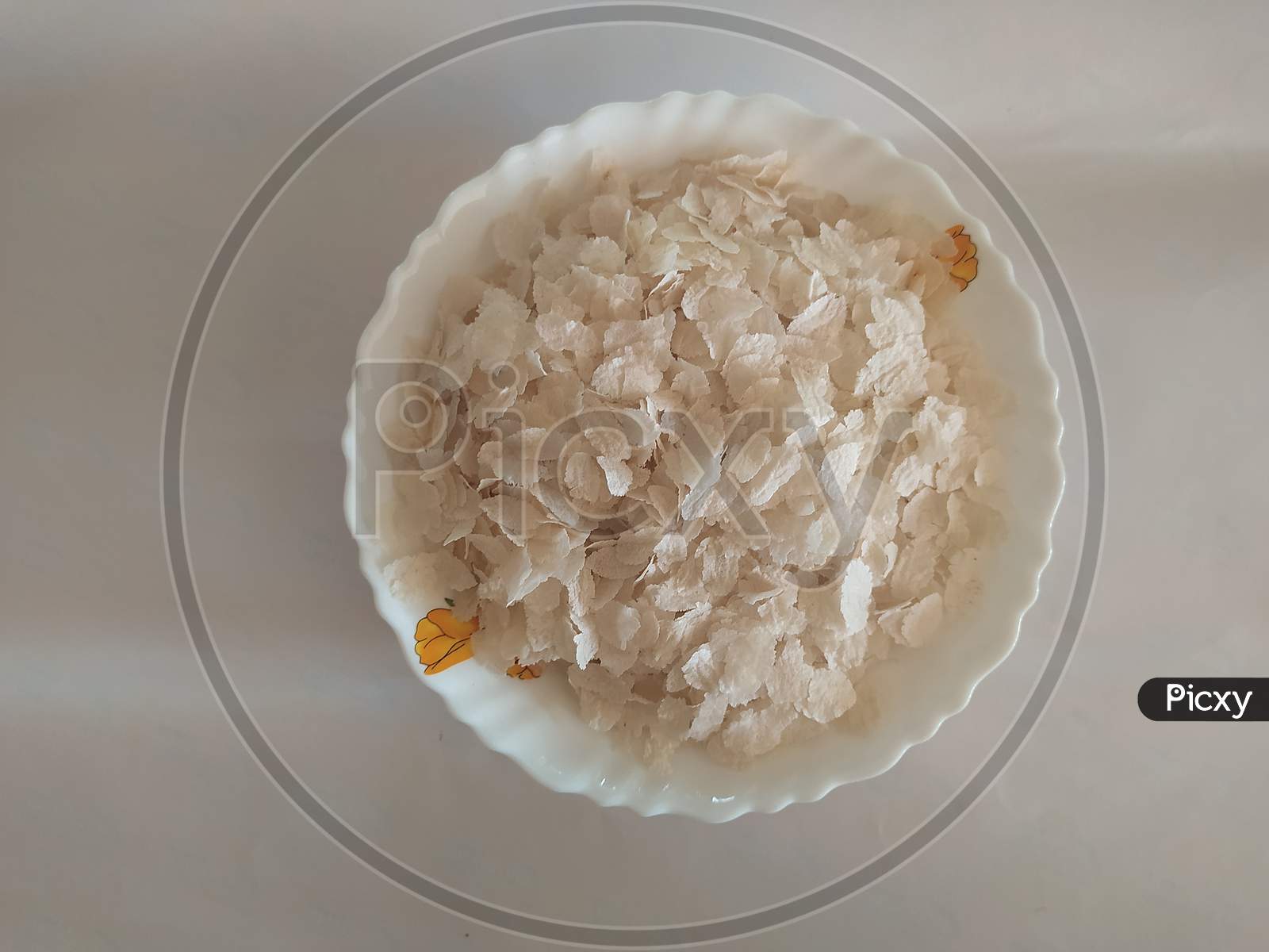 Closeup Of Beaten Rice In A Bowl Isolated On A White Background