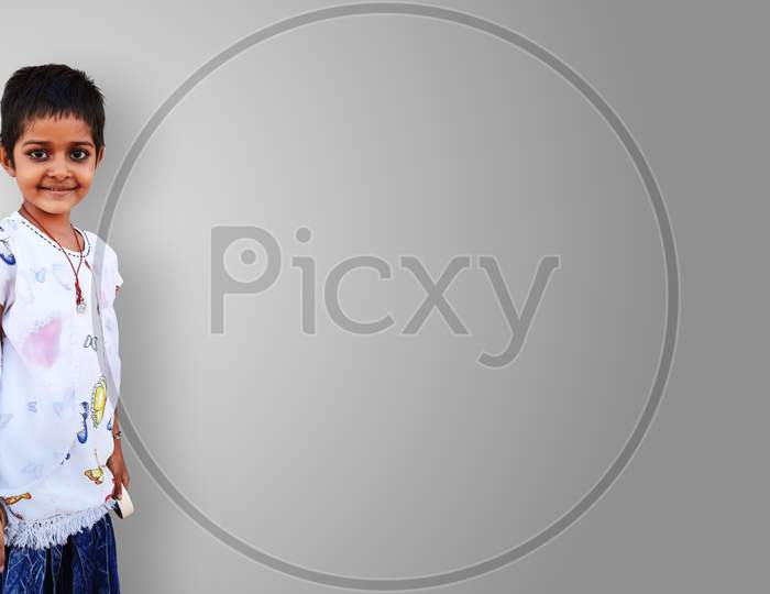 Pretty Indian Little Girl Standing And Smiling Isolated In White
