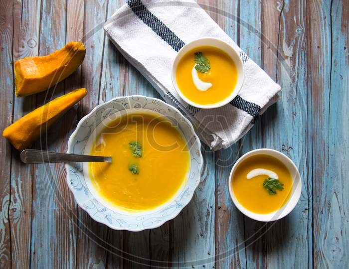 Top view of fresh home made pumpkin soup in a bowl served in two small bowls