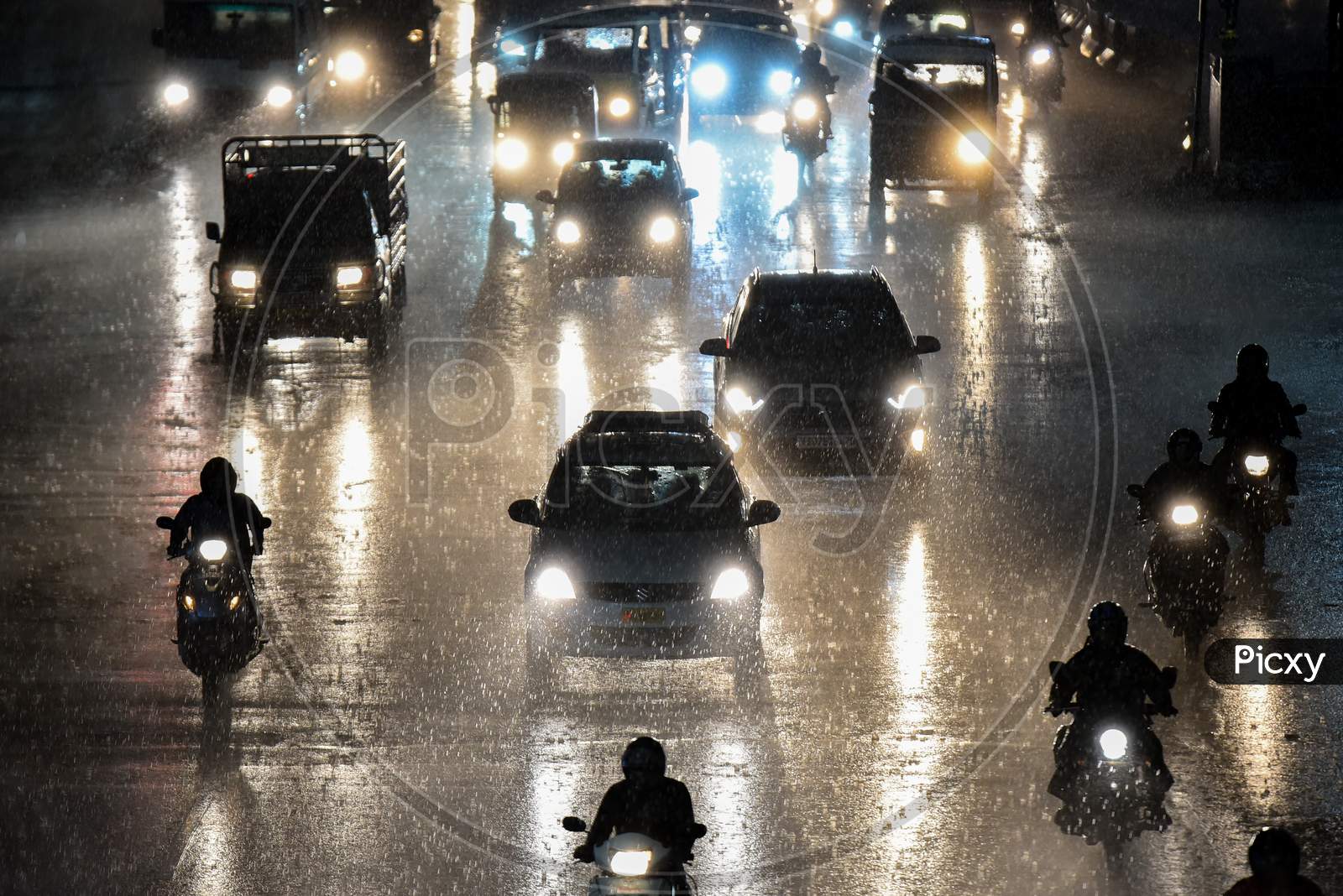 Motorists wade through a heavy rain in Hyderabad on September 16,2020.