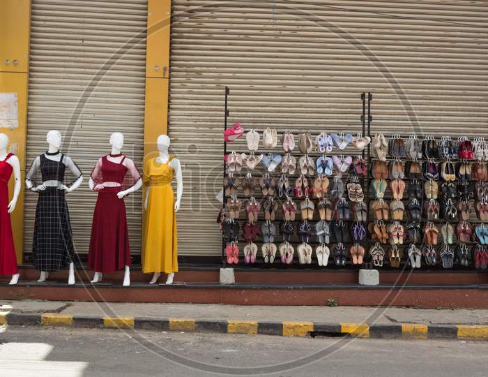 An Elegant picture of a Bewitching Mannequins dressed in Colorful Indian clothing and the Fancy Footwear Display at a street  store in Mysuru cityscape of Karnataka state in India.