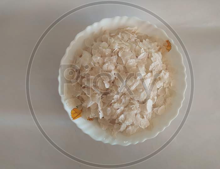 Closeup Of Beaten Rice In A Bowl Isolated On A White Background
