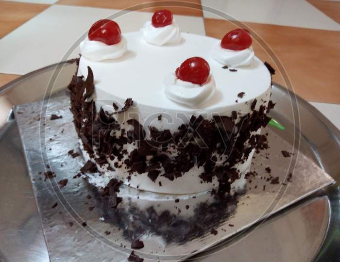 home made black forest cake with cherry on top