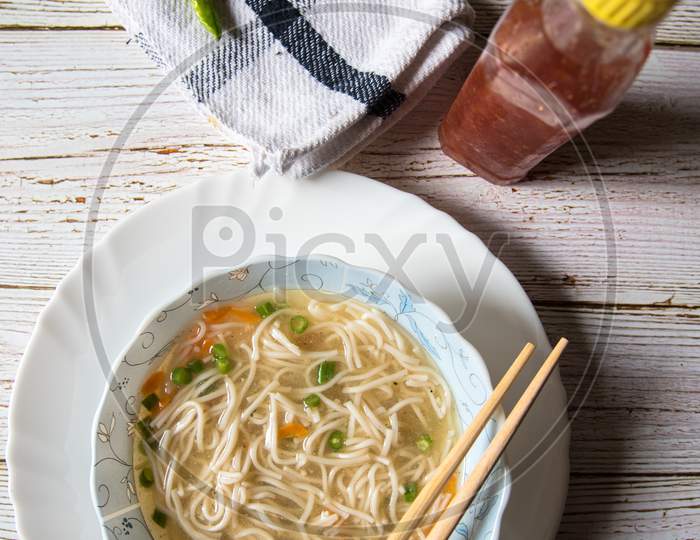 Delicious thukpa noodles in a bowl with condiments