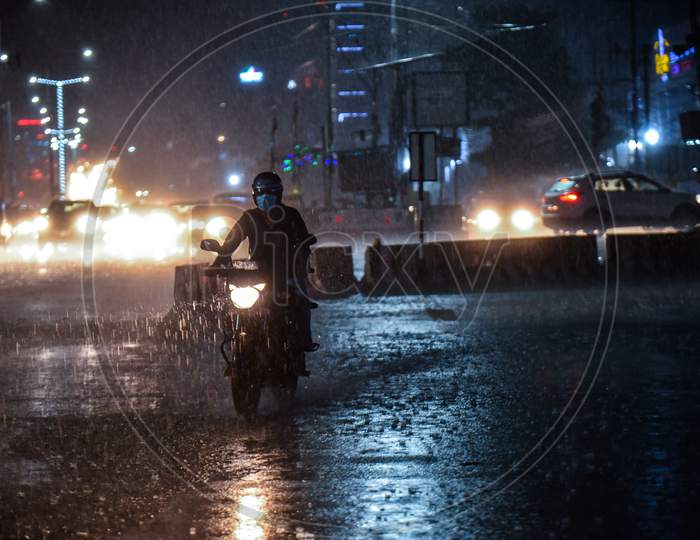 a motorist wades through a heavy rain in Hyderabad on September 16, 2020.
