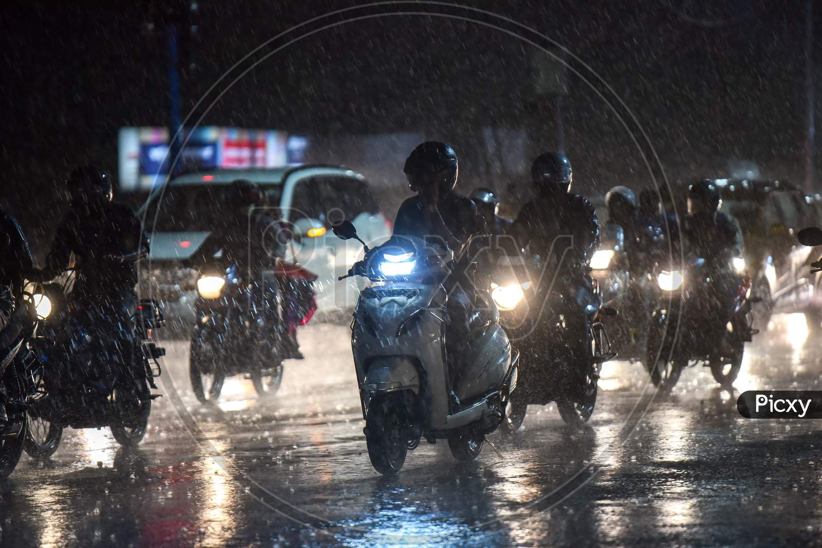Motorists wade through a heavy rain in Hyderabad on September 16,2020.