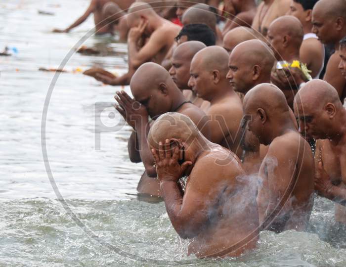People pray as they take a dip in a lake to honour the souls of their departed ancestors on the last day of Sarva pitru amavasya, amid the spread of the coronavirus disease (COVID-19) in Mumbai, India on September 17, 2020.