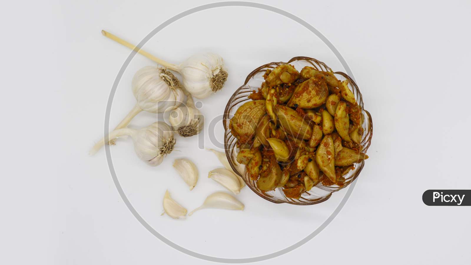 Homemade spicy fresh garlic pickle on white background From top shoot.