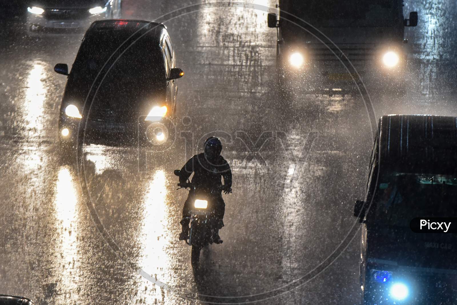 motorists drive on road as it rains heavily in Hyderabad on september 16,2020.