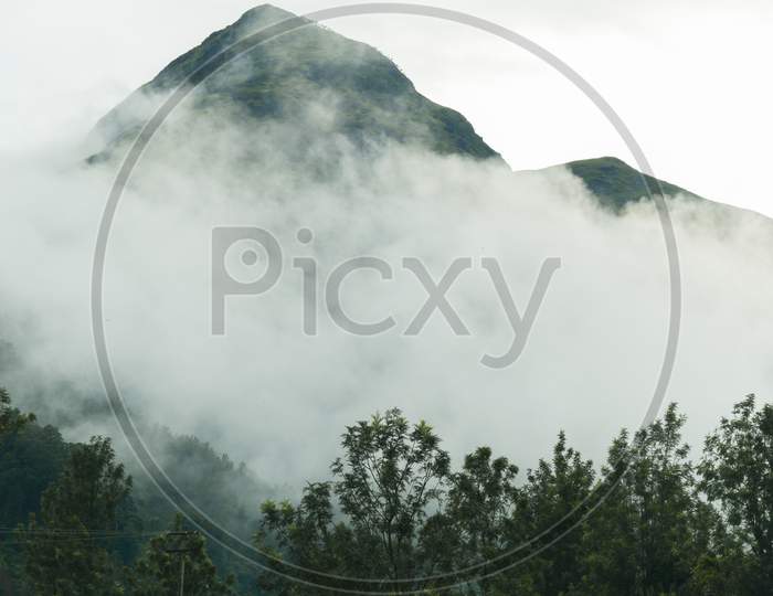 Portrait View Wallpaper Of Green Lush Mountain In Western Ghats Covered In Mist And Fog, Morning View Of Chembra Peak, Meppadi, Wayanad.