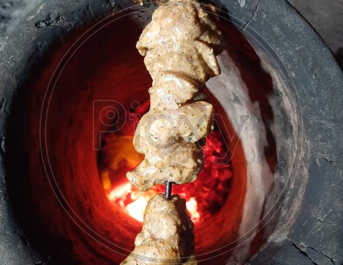 Chicken being roasted on Tandoor