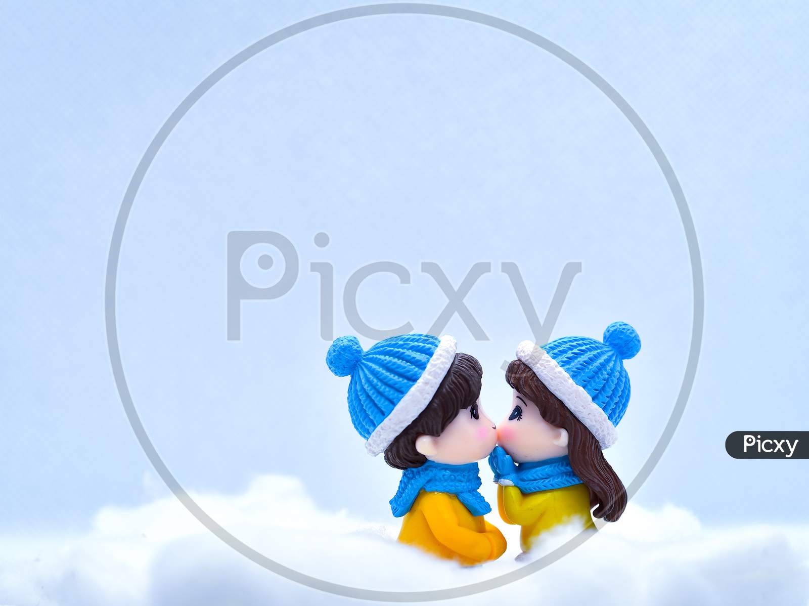 Tourism And Travel Concept: Miniature People Kissing Each Other In Winter Snow